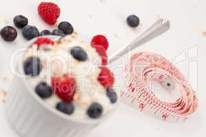 Tape measure and a dessert of berries