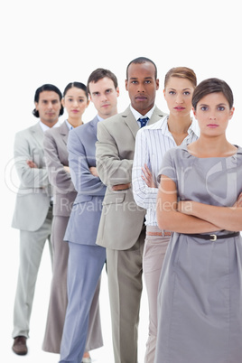 Close-up of a serious business team crossing their arms in a sin