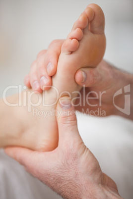 Close-up of two hands massaging a foot