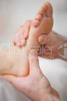 Close-up of two hands massaging a foot