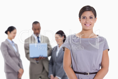 Woman business team in the background watching a laptop