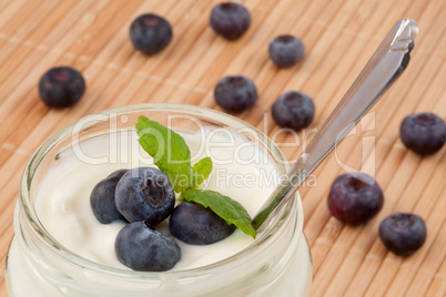 Close up of many blueberries in a pot of yogurt