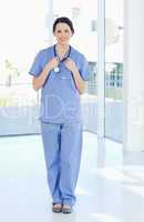 Smiling medical intern wearing a blue short-sleeve uniform