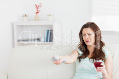 Woman sitting on a sofa while holding a glass of wine