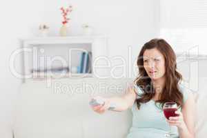 Woman sitting on a sofa while holding a glass of wine