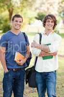 Portrait of two standing handsome students talking