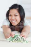 Woman holding a few dollar bills