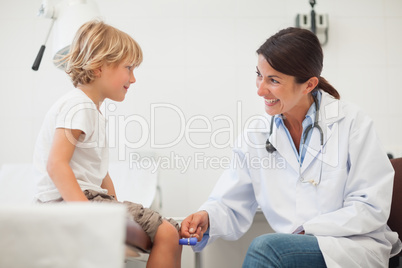 Female doctor auscultating a child