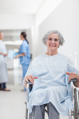 Elderly patient in a wheelchair in a corridor
