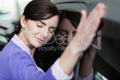 Woman resting on a car