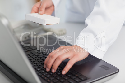 Doctor typing on a laptop