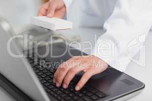 Doctor typing on a laptop
