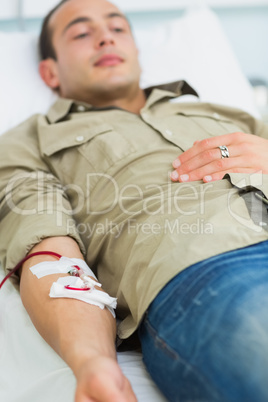 Male transfused lying on a bed