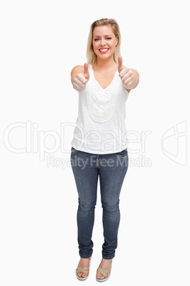 Joyful blonde woman placing her thumbs up