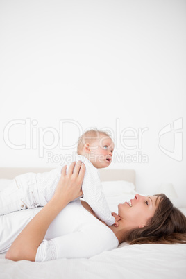 Cheerful woman holding her cute little girl