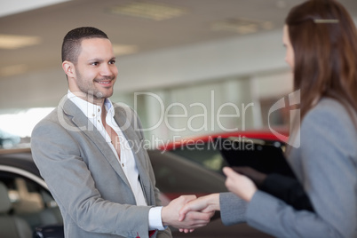 Businesswoman shaking hand of a client