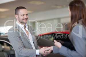 Businesswoman shaking hand of a client