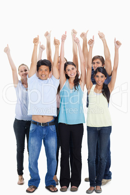 People smiling together raising their arms with their thumbs-up