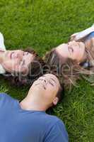 Three students lying together