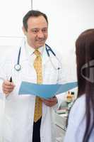 Smiling doctor talking to his patient