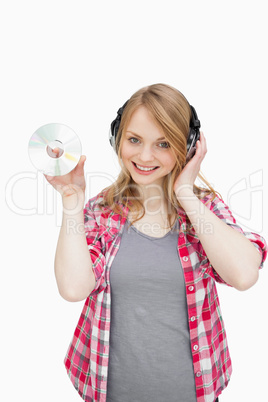 Woman standing while holding a cd