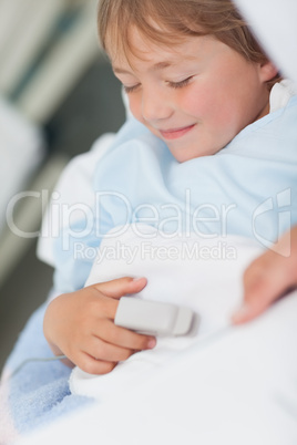 Smiling child lying on a medical bed