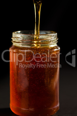 Honey trickle dropping in a honey jar