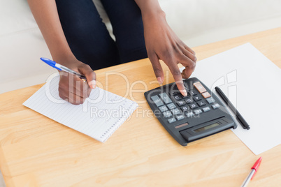 Close up of a woman using a calculator