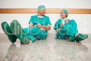 Surgeons talking while sitting in the floor