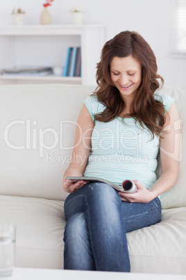 Woman smiling while reading a magazine