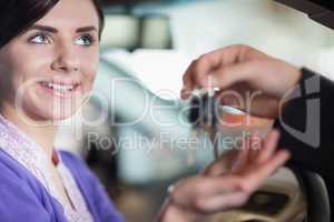 Woman smiles as she takes car keys