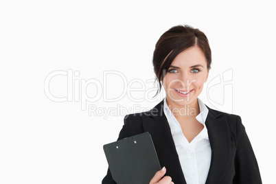 Smiling woman in suit holding a clipboard