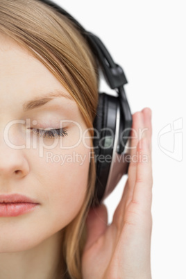 Close up of a woman with closed eyes listening music