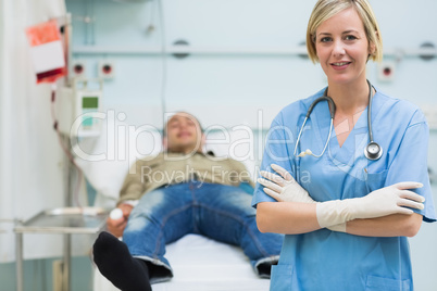 Nurse next to a male patient with arms crossed