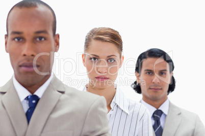 Big close-up of a serious business team in a single line