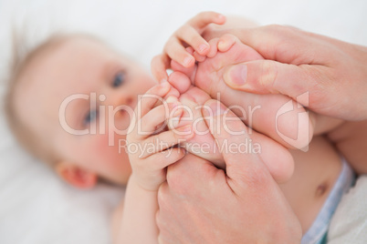 Feet of a cute little girl being held