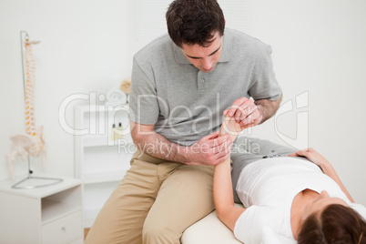 Physiotherapist looking at the wrist of a patient