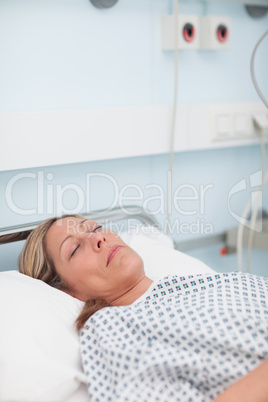 Female patient lying on a bed while closing her eyes