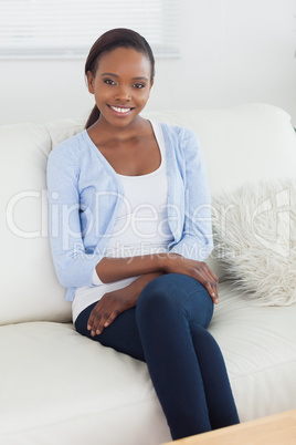 Black woman sitting on a sofa