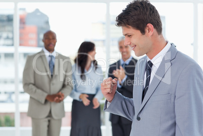 Young businessman using his fist to show his success