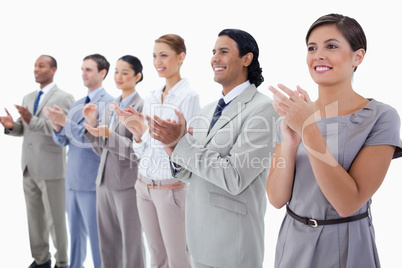 Close-up of colleagues smiling and applauding