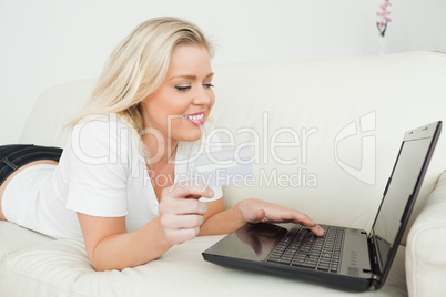Woman looking at a laptop and holding a credit card