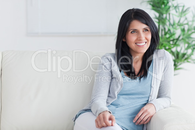 Smiling woman relaxing on a sofa