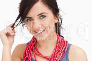 Smiling blue eyed woman with a red bead necklace
