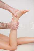 Podiatrist manipulating the ankle of his patient
