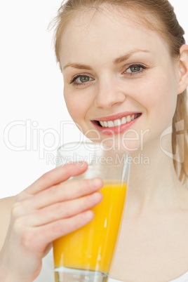 Cheerful woman holding a glass of orange juice