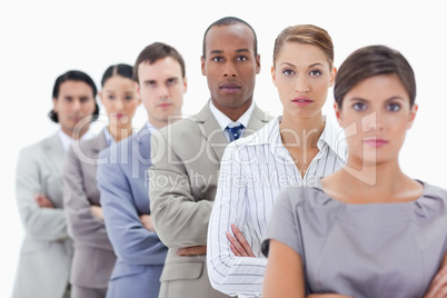 Big close-up of a serious business team in a single line crossin