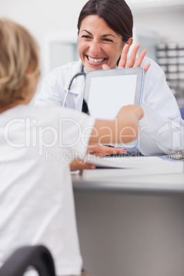 Child touching the tablet computer of a doctor