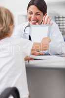 Child touching the tablet computer of a doctor