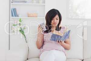 Woman holding a mug and a book